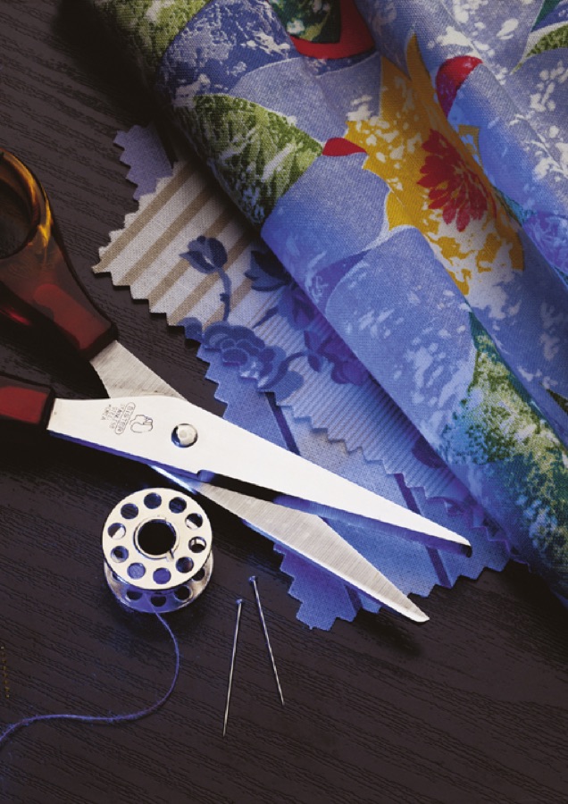 Archive photograph: dressmaking scissors and bobbin beside fabric printed in Holliday ultramarine