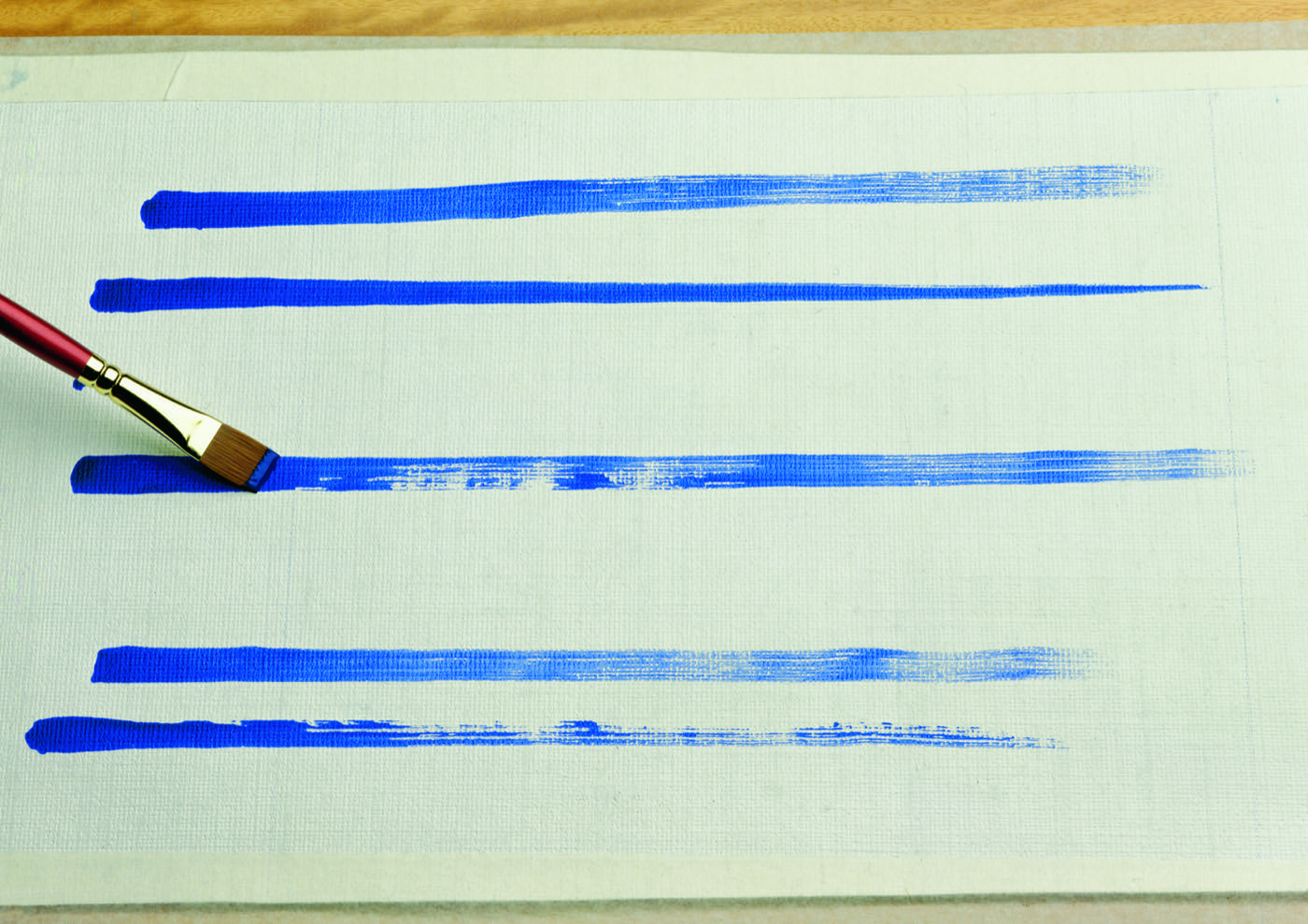 Ultramarine draw-down strips brushed onto a test card for colour strength assessment