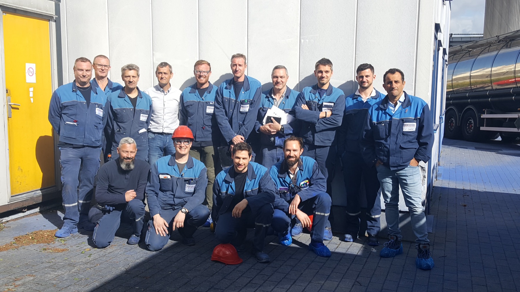 The Holliday production team outside the Comines works